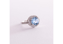 Серебряное помолвочное кольцо с голубым 
топазом и фианитами